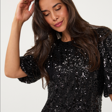 Load image into Gallery viewer, A woman wearing a black sequined short-sleeve top with puff sleeves, posing against a plain white background.
