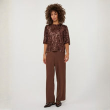 Load image into Gallery viewer, A woman modeling a brown sequined short-sleeve top and matching brown wide-leg trousers against a plain light gray studio background.
