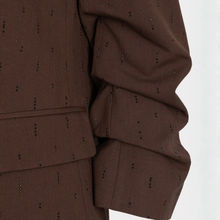 Load image into Gallery viewer, Close-up of a brown textured fabric garment with small black dotted vertical patterns, showing the sleeve and waist detail against a white background.
