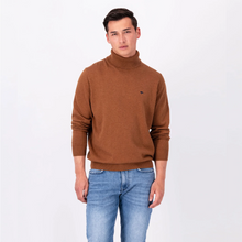 Load image into Gallery viewer, Model wearing the Walnut Brown coloured Fynch Hatton Polo Neck with sleeves pushed up too elbows, wearing blue jeans
