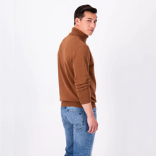 Load image into Gallery viewer, Model looking over shoulder wearing a Walnut Brown polo neck with blue jeans
