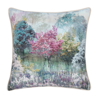 Decorative pillow with a nature-themed design featuring trees and flowers.