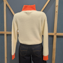 Load image into Gallery viewer, Back of Twns The Label Breckenridge White/Neon Orange, with a wooden and blue background.
