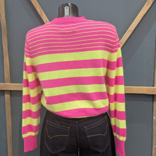 Load image into Gallery viewer, Back of Twns The Label Orleans Neon Pink/Yellow set on a mannequin, with a wooden and blue background.
