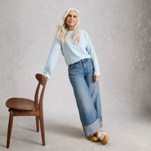 Load image into Gallery viewer, Lady leaning into chair with jeans and stripe top
