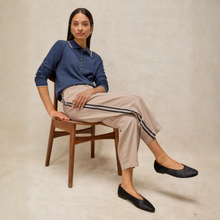 Load image into Gallery viewer, Lady sitting on chair with natural trousers with stripe and blue top
