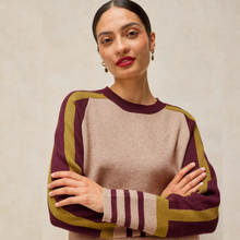 Load image into Gallery viewer, A woman modeling a long-sleeve knit sweater with a beige body and maroon and olive green raglan sleeves
