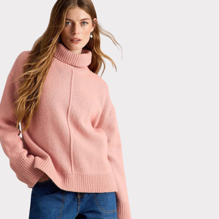 Model wearing White Stuff MARIANNE Jumper in Dusty Pink, showing the relaxed fit and soft roll neck.