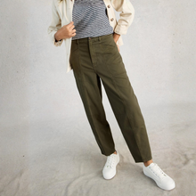 Load image into Gallery viewer, Person wearing olive green pants, a striped shirt, and white sneakers on a plain background
