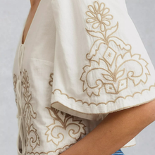 Load image into Gallery viewer, White garment with gold embroidery on a plain background
