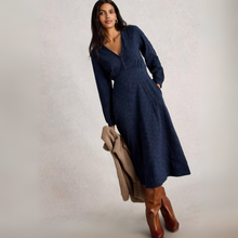 Load image into Gallery viewer, Woman wearing a navy blue dress with brown boots and a beige cardigan on a plain background

