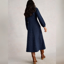 Load image into Gallery viewer, Woman wearing a long blue dress and brown boots on a plain background
