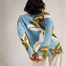 Load image into Gallery viewer, Person wearing a colorful sweater with abstract pattern on a plain background
