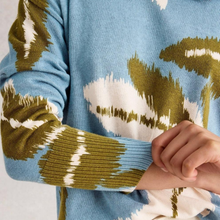 Load image into Gallery viewer, Close-up of a blue sweater with green and white patterned sleeves.
