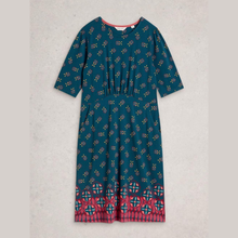 Load image into Gallery viewer, Teal dress with a patterned hem on a light gray background
