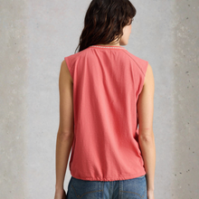 Load image into Gallery viewer, Person wearing a coral sleeveless top against a gray concrete wall
