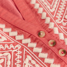 Load image into Gallery viewer, Close-up of a coral fabric with white embroidery and buttons.

