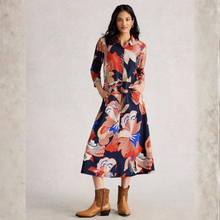 Load image into Gallery viewer, Woman wearing a colorful floral dress with brown boots on a light gray background
