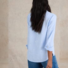 Load image into Gallery viewer, Person wearing a light blue shirt with rolled-up sleeves against a beige wall
