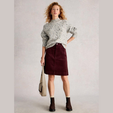 Load image into Gallery viewer, Woman wearing a patterned sweater and maroon skirt holding a beige bag against a plain background
