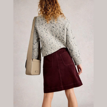 Load image into Gallery viewer, Person wearing a patterned sweater and maroon skirt with a beige bag on a plain background
