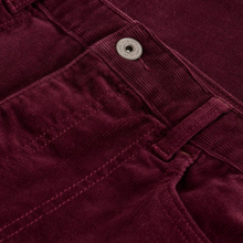 Load image into Gallery viewer, Close-up of burgundy corduroy pants with a button detail
