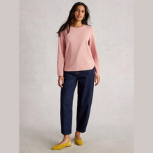 Load image into Gallery viewer, Woman wearing a pink sweater and navy pants on a plain background
