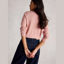 Load image into Gallery viewer, Woman wearing a pink sweater and blue jeans against a light gray background
