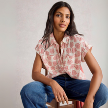 Load image into Gallery viewer, Woman wearing a floral blouse and jeans sitting on a chair against a plain background
