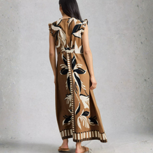 Load image into Gallery viewer, Woman wearing a long, patterned dress against a plain background
