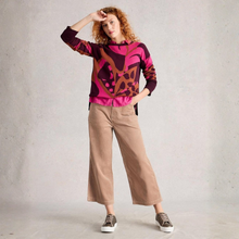 Load image into Gallery viewer, Woman wearing a colorful sweater and beige pants against a plain background
