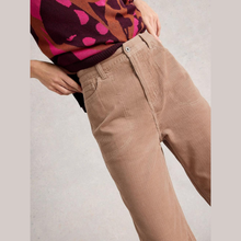 Load image into Gallery viewer, Beige corduroy pants worn with a colorful sweater on a neutral background
