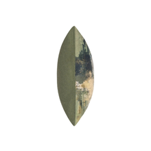 Load image into Gallery viewer, A single oval decorative throw pillow shown upright on a plain white background. The left half is solid olive green fabric, while the right half features an abstract landscape-style print in muted green, beige, and dark charcoal tones.
