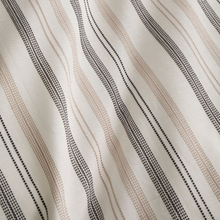 Load image into Gallery viewer, Close-up of fabric with wavy black lines on a beige background
