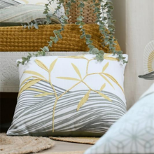 Load image into Gallery viewer, A square decorative throw pillow with a white background, featuring embroidered yellow bamboo leaves and gray wavy stripes, styled in a cozy home setting.
