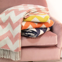 Load image into Gallery viewer, Stack of folded throws on a pink chair, lifestyle image
