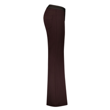 Load image into Gallery viewer, A pair of dark brown flared pants shown from a side profile view against a plain white background.
