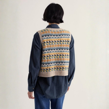 Load image into Gallery viewer, A person shown from the back wearing a navy blue corduroy shirt and a knit vest with a geometric Fair Isle pattern in beige, mustard yellow, and blue, set against a plain off-white background.
