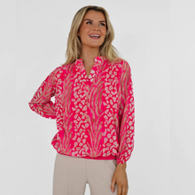 Load image into Gallery viewer, Female model looking away from camera wearing pink top looking away smiling with one hand on hip

