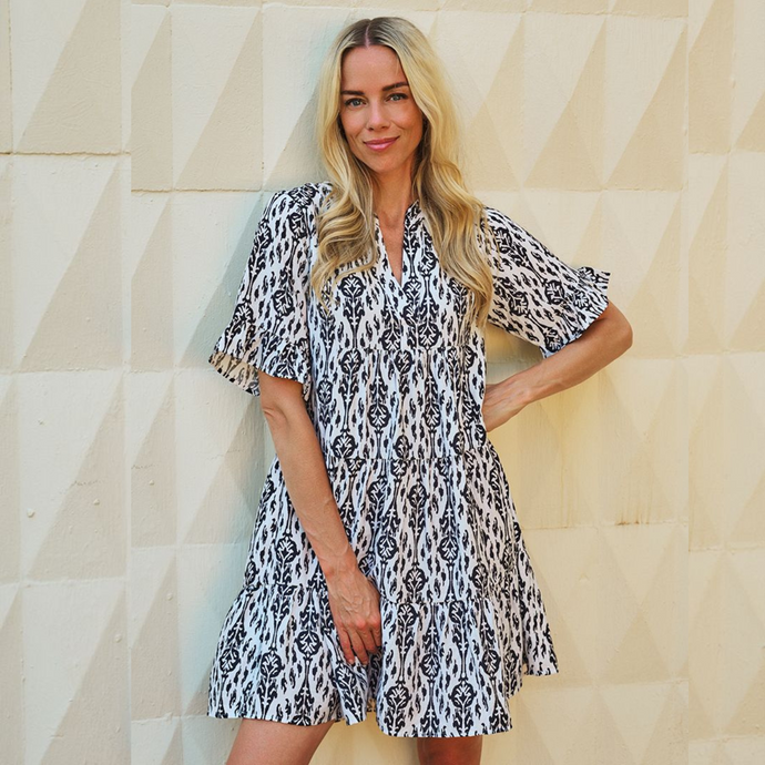 Image of a model wearing  Esqualo Two Tone Dress featuring a vibrant Ikat print. Designed with a relaxed, loose fit, 