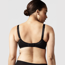 Load image into Gallery viewer, A model displaying the back details of the Chantelle Hedona Minimiser Bra in Black
